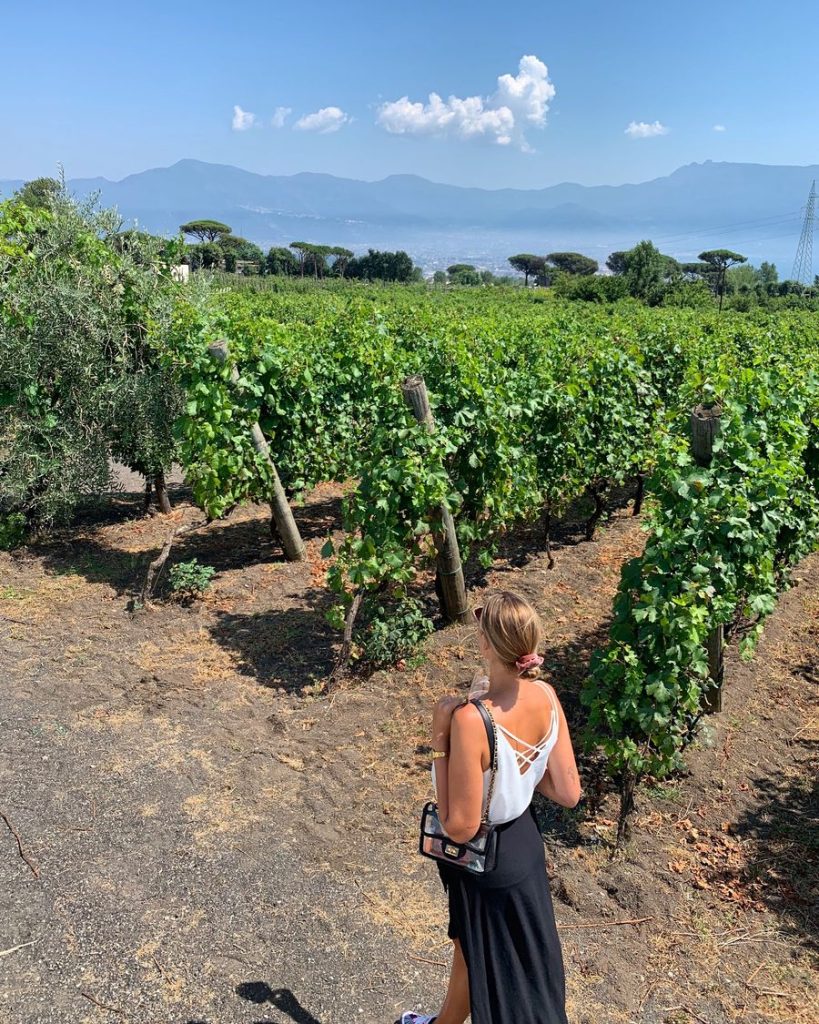 local girl in vineyard on vesuvius with wine